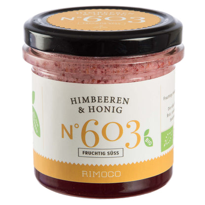 Ein Glas Himbeeren & Honig Aufstrich mit weiß-gelbem Etikett.
