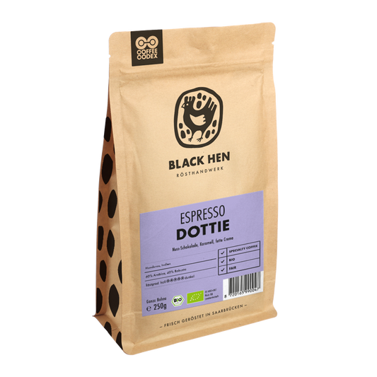 Bio Espresso DOTTIE in brauner Tüte mit lila Etikett und schwarzem Hennenlogo vorne.