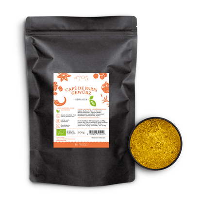 Geöffnete Dose mit gelbem Bio Café de Paris Gewürz, daneben schwarze Tüte mit sichtbarem Etikett.