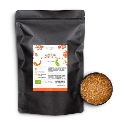 Schwarzer Beutel Bio Coffee To Grill Rub neben offenem Behälter Kakao Gewürzmischung.