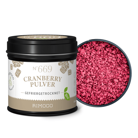 Bio Cranberry Pulver im geöffneten Glas neben dem Deckel, mit leuchtend pinkem Pulver sichtbar.