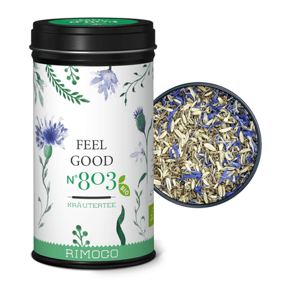 Bio Kräutertee Feel Good Dose, daneben loser Kräutertee mit Anis und blauen Blütenblättern.