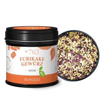 Gemisch aus bunten Gewürzflocken neben einer Bio Furikake Gewürzdose.