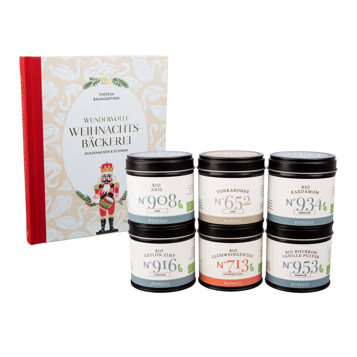 Sechs Gewürzdosen vor dem Buch Wundervolle Weihnachtsbäckerei mit rotem Buchrücken.