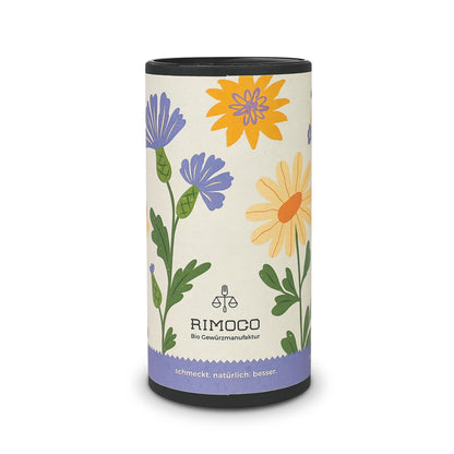 Geschenkverpackung mit Rimoco-Logo und bunten Blumenmotiven auf weißem Hintergrund.