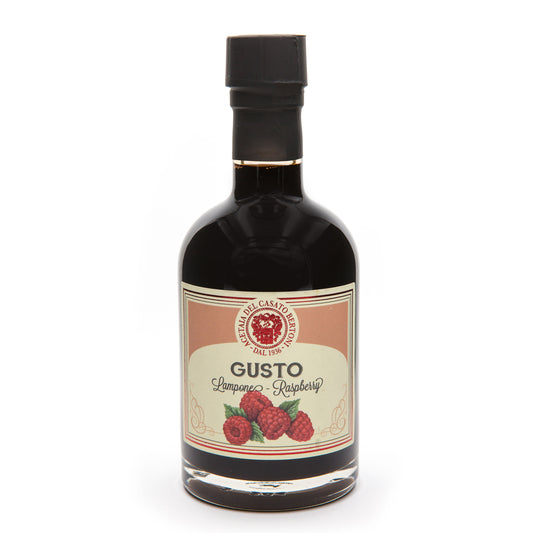 Bertoni Himbeer-Balsamico Condimento in dunkler Glasflasche mit Himbeerbild und rotem Etikett.