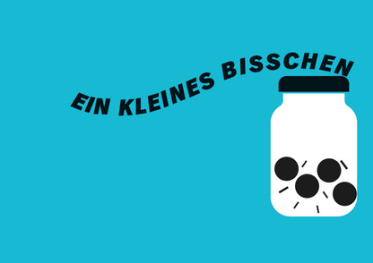 Glas mit schwarzen Kreisen und Aufschrift EIN KLEINES BISSCHEN.