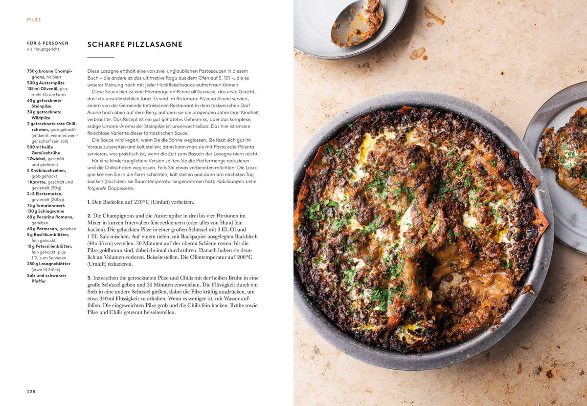 Eine gebackene Pilzlasagne in einer runden Form auf hellem Tisch, daneben Geschenkset Ottolenghi Flavour.