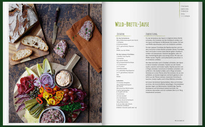 Rustikaler Aufstrich mit Brot, Pastete, Käse, Gemüse und einem Einfach mal Wild Kochbuch.