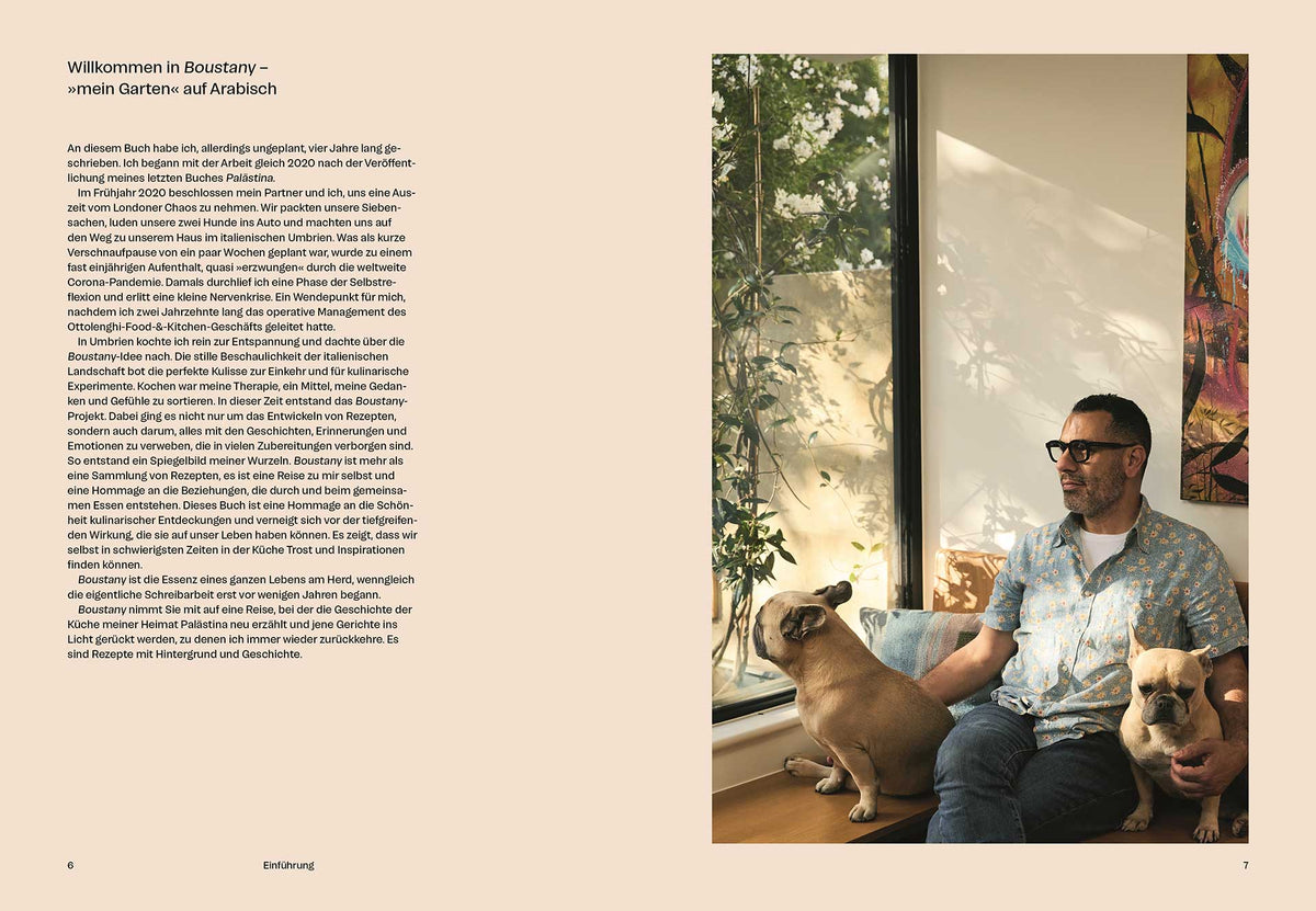 Ein Mann sitzt mit zwei Hunden auf dem Sofa, neben ihm am Fenster das Geschenkset Boustany.