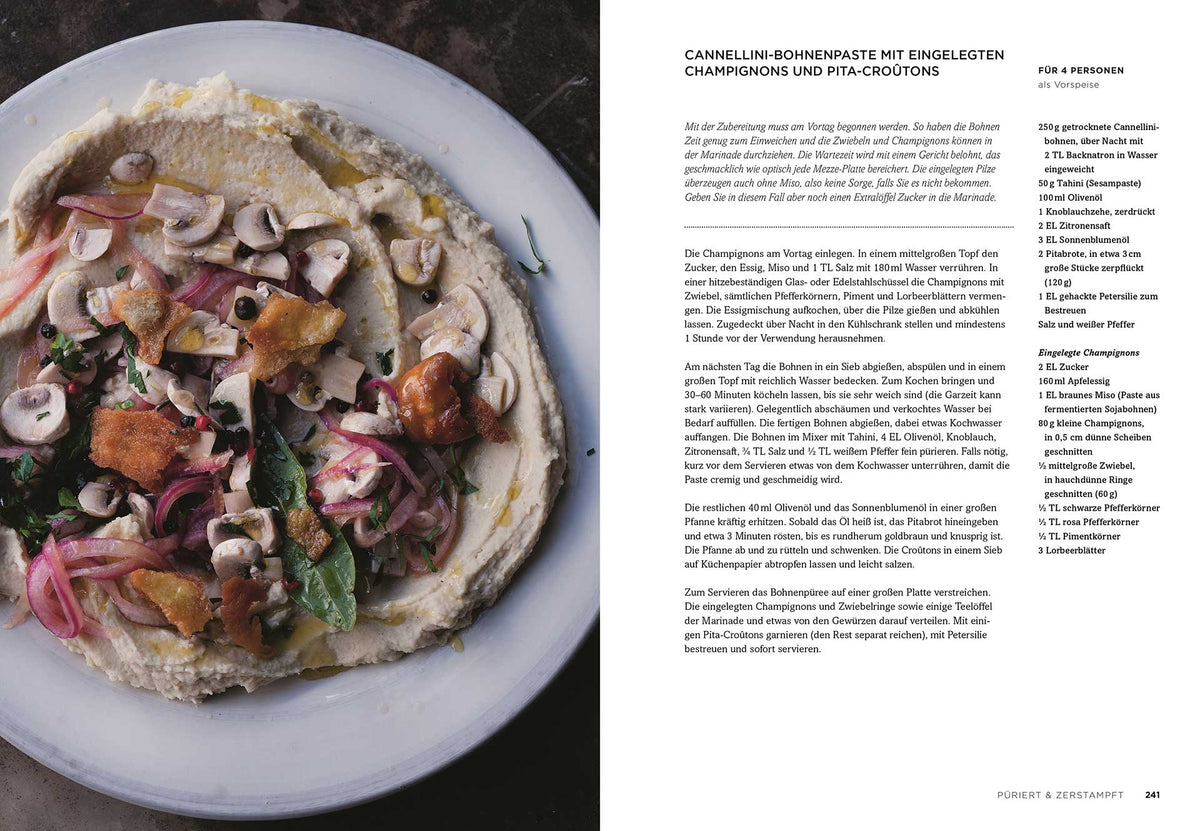 Teller mit Bohnenaufstrich, Pilzen, Blattgemüse und Pita. Vegetarische Köstlichkeiten Yotam Ottolenghi.