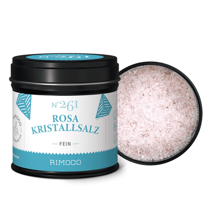 Schwarze Dose mit Aufschrift Rosa Kristallsalz fein neben offenem Behälter mit rosa Salz.