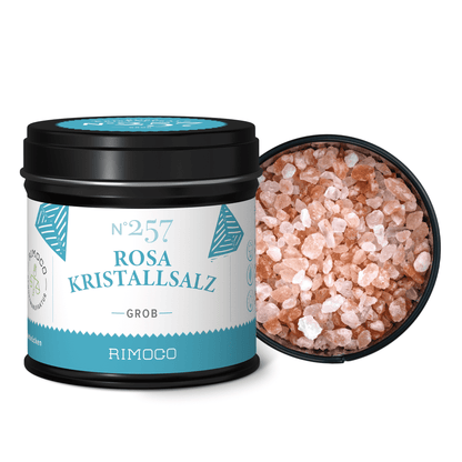 Schwarzer Behälter mit Aufschrift Rosa Kristallsalz grob, Deckel offen, grobes rosa Salz sichtbar.