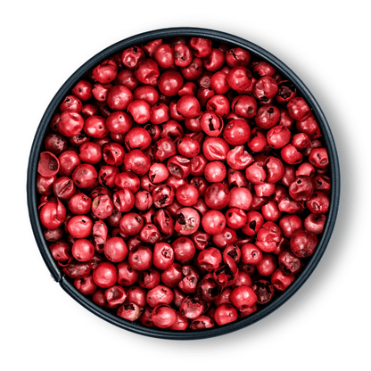 Schale mit Bio Rosa Pfeffer von oben auf weißem Hintergrund.