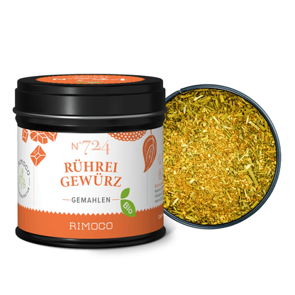 Geöffnete Dose mit leuchtend gelb-grünem, grobem Gewürz.
