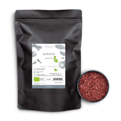 Bio Sumach gemahlen in schwarzer Packung, daneben eine Schale mit rotem, gemahlenem Sumach von oben.