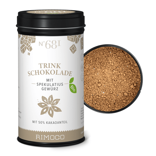 Bio Trinkschokolade mit Spekulatiusgewürz neben offenem Deckel, Kakaopulver sichtbar.