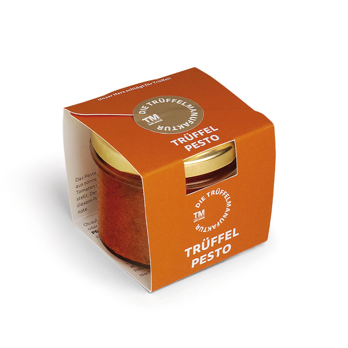Trüffel Pesto in einem kleinen Glas mit orangener Kartonverpackung.